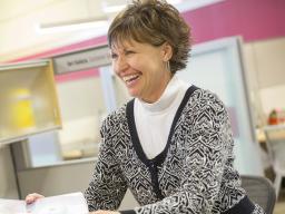 Teri Kaluza smiles as she hands a project off to a customer in the Pixel Lab. Kaluza is among the women who have been featured by the Chancellor's Commission on the Status of Women. 