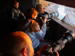 Mike Forsberg (on left) and University of Nebraska–Lincoln students view sandhill cranes from a blind of the Crane Trust during his Prairie Cranes and Sandhill Chickens class in spring 2024. Photo courtesy of Carlee Moates