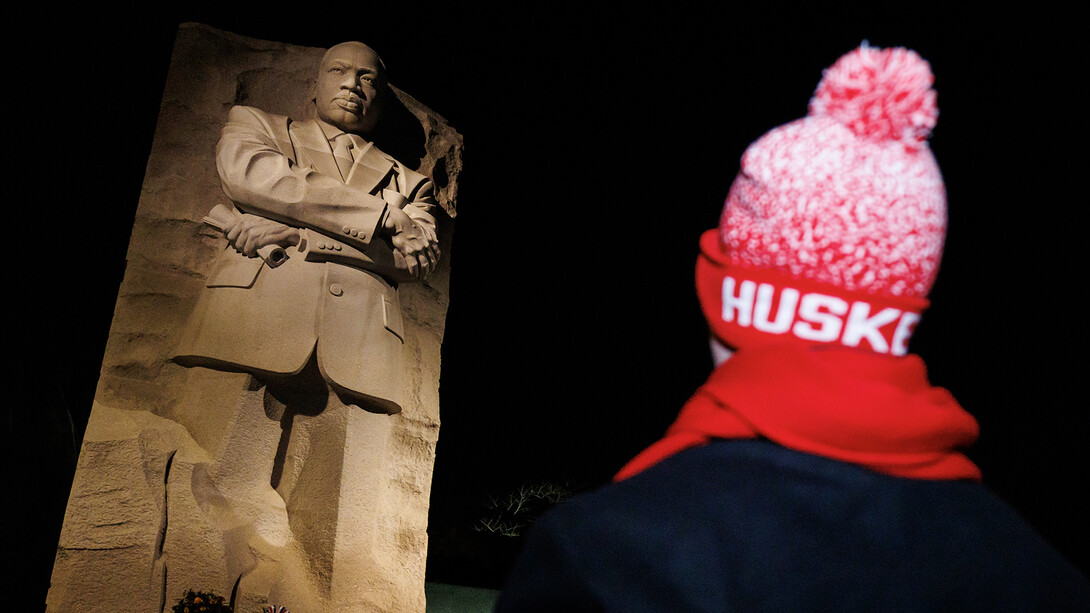 A student stands looking up to the Dr. Martin Luther King Jr. memorial in Washington, D.C.