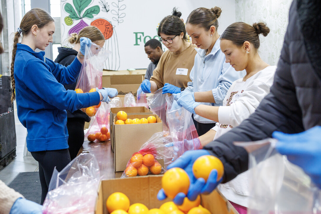 University of Nebraska&ndash;Lincoln students place oranges into bags during SLICE&rsquo;s Engage Lincoln volunteer project at the Food Bank of Lincoln on Jan. 30.