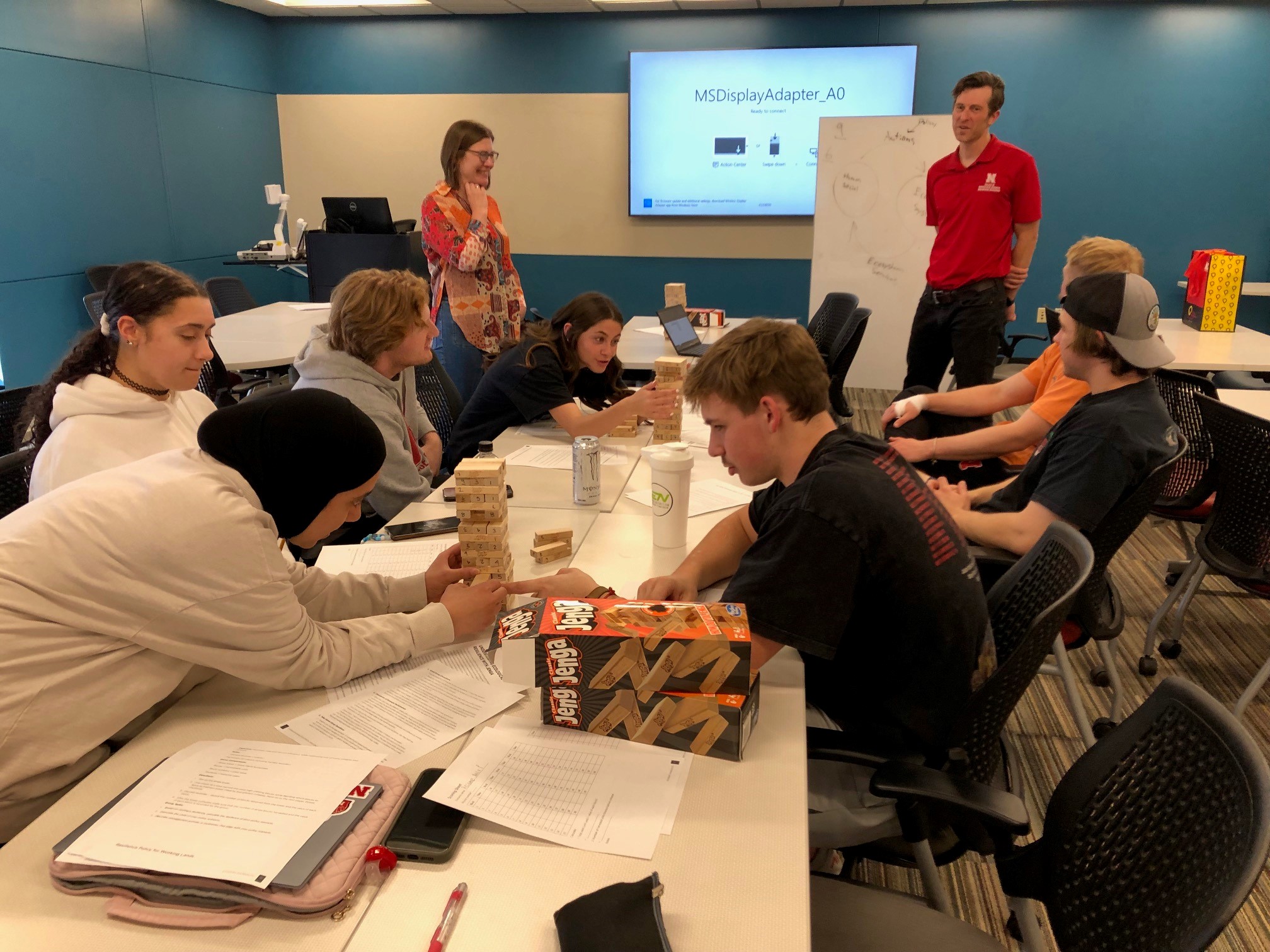 Daniel Uden (standing at right) and Jenny Keshwani  uses Jenga® game sets to teach ecological resilience concepts to students. 