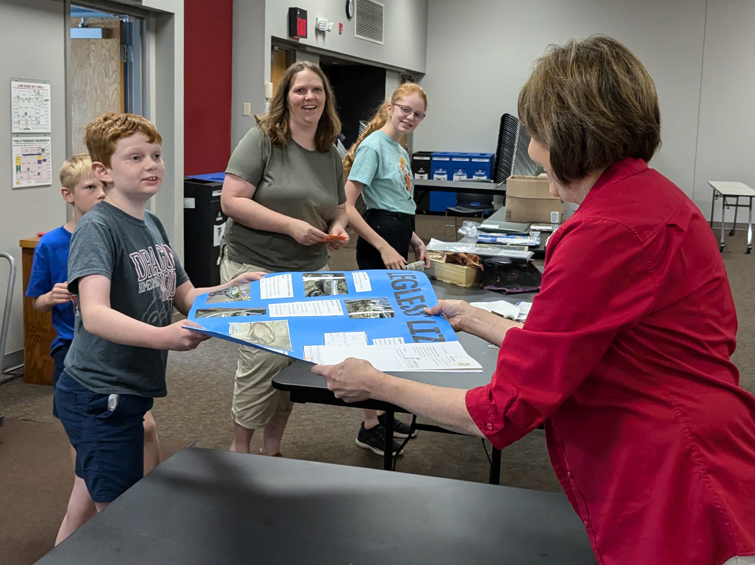 Ian Bettenhausen and family bringing their 4-H static exhibits for the Nebraska State Fair to the Extension office in 2024
