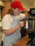 Dairy Store employee and UNL senior Sarah Ward steams milk for an espresso.