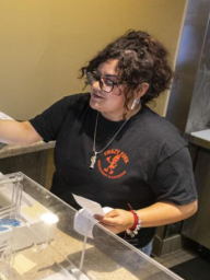 Vianka Curiel giving a receipt to a customer.