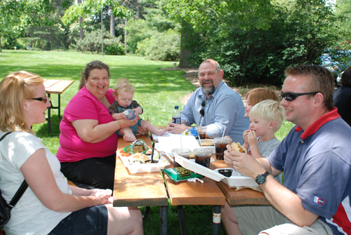 A group of P.O. Pears patrons enjoy their burgers on a sunny day.