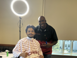 A photo of a student and a barber