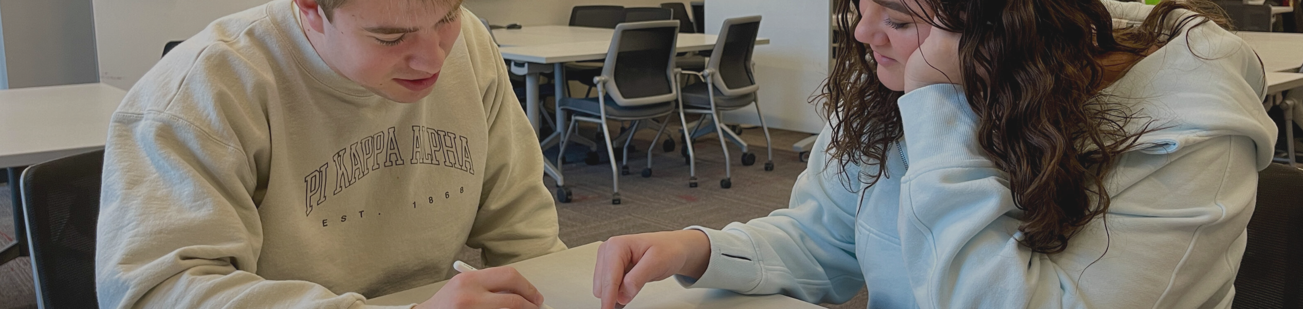 A student and a tutor looking over work for a course