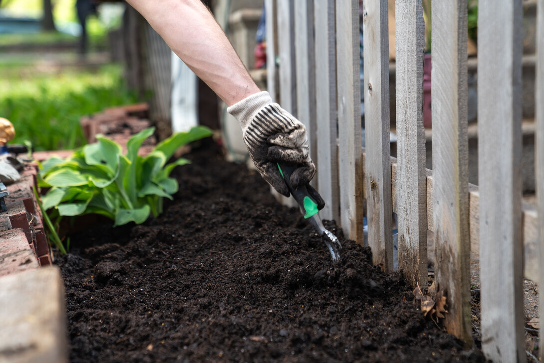 Delta Phi Fraternity volunteers till a soil to create a fairy garden during the Big Event. May 4, 2024. Photo by Kirk Rangel 