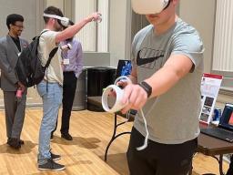 Students present and test a VR project at the 2023 Senior Design Showcase in May.