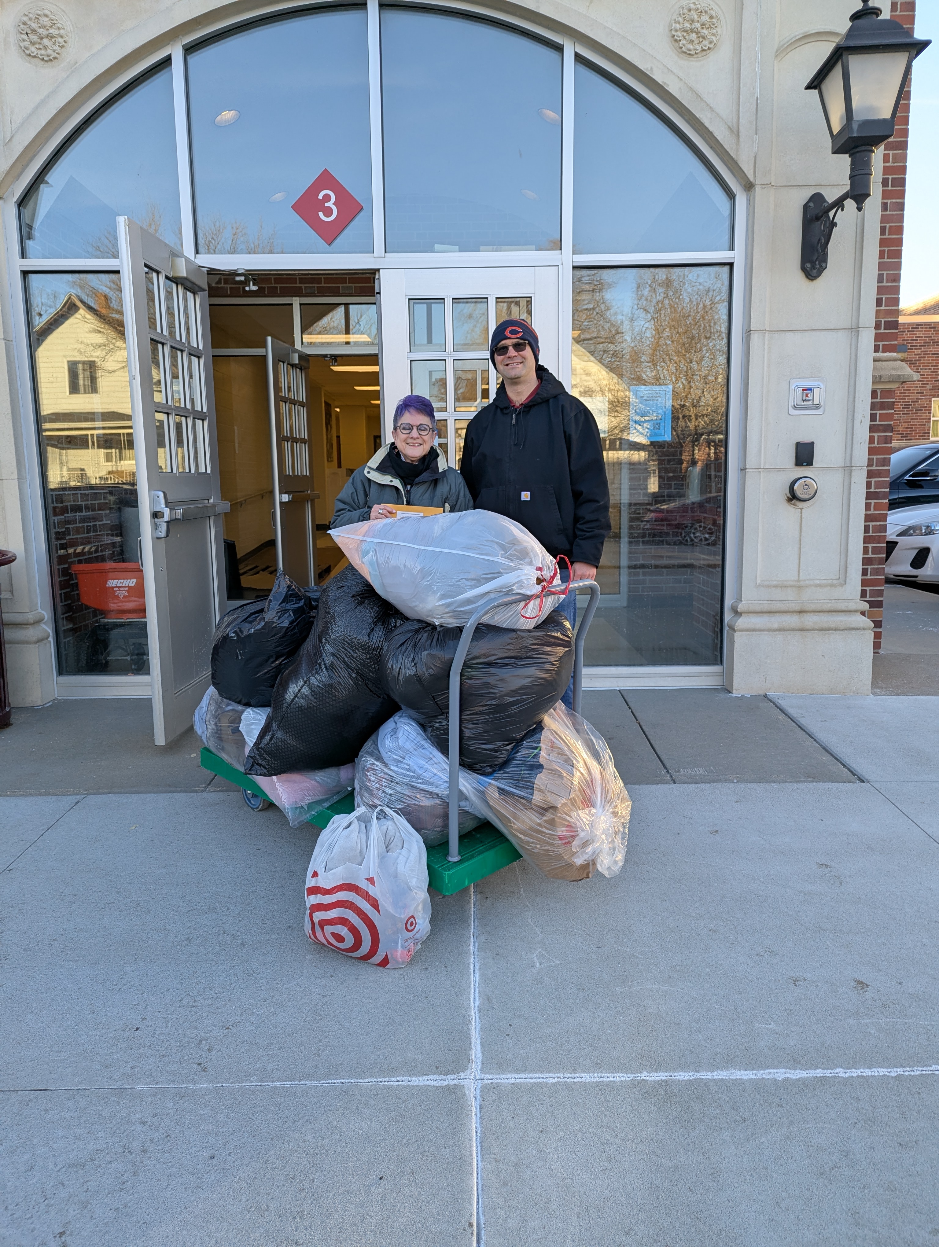 Linda Kern(left), Care Coordinator at Clinton, and Eric Hunt, SNR Faculty exchanging Caring for Clinton donations.