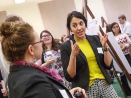 UCARE scholar presenting research at symposia to faculty mentor.