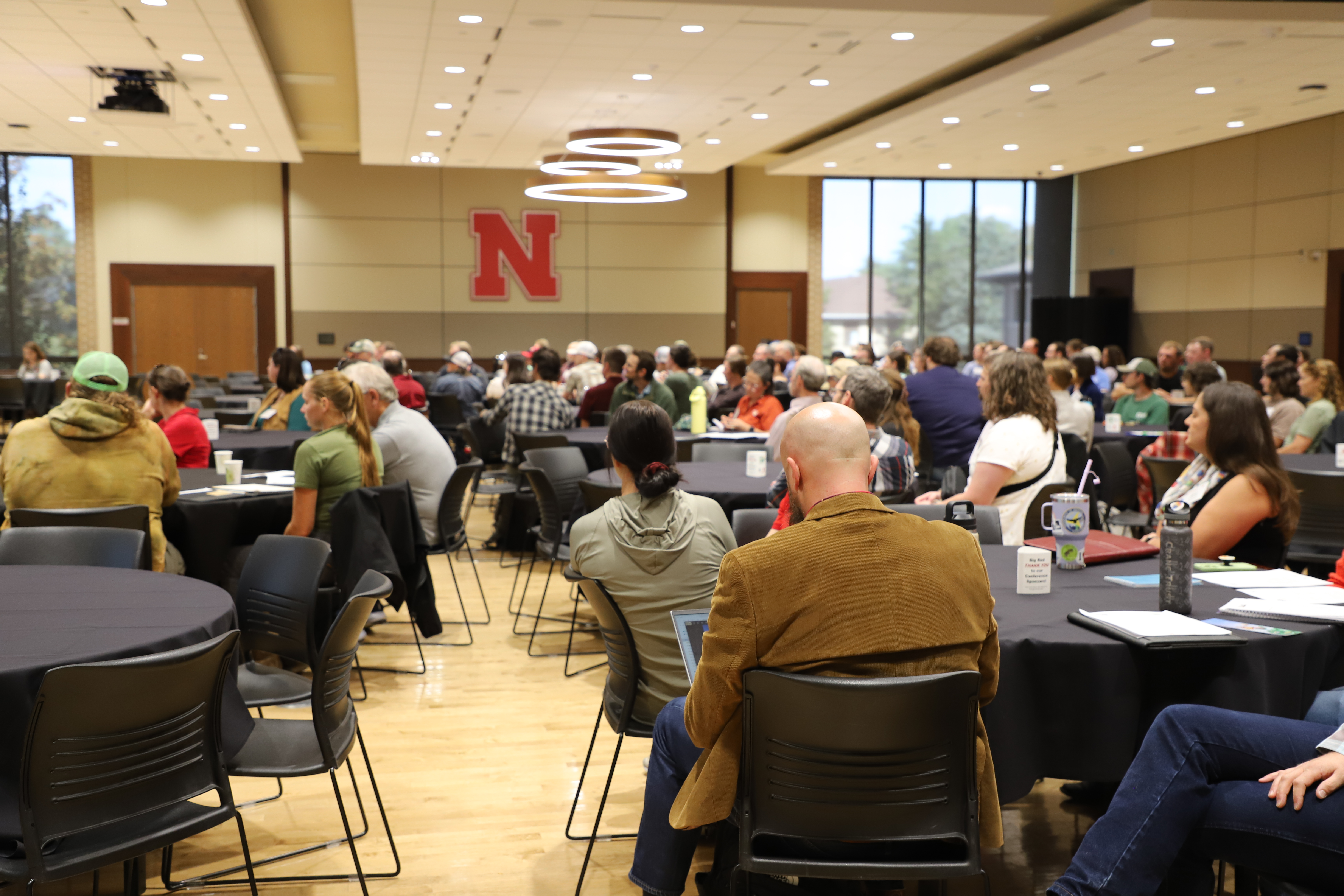 Conference attendees listen to a talk by Cheryl Dunn.