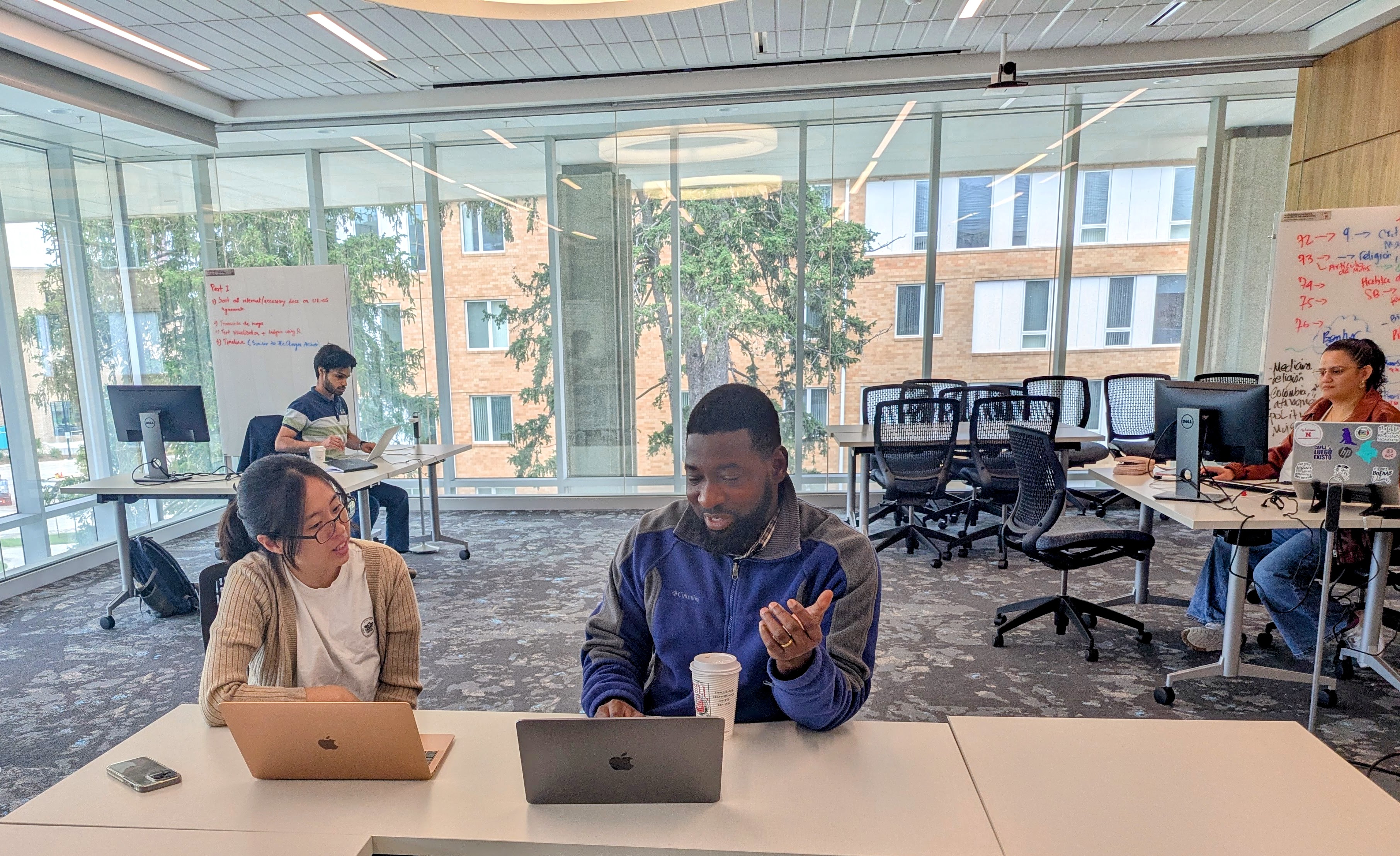 2025 DH Summer Fellows Eunhong Lee and Babatunde Okunlola working together in the Dinsdale Family Learning Commons.