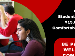 image of two students sitting at a table in conversation