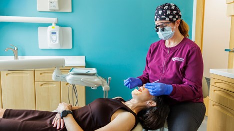 dental hygienist examining a patient