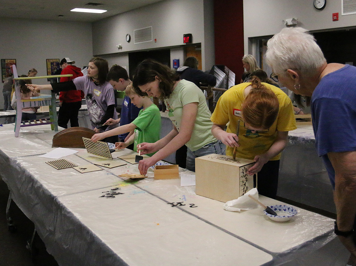4-H'ers working on their projects at the 2025 4-H Home Decor & Furniture Painting workshop.