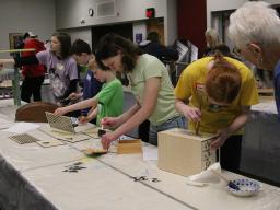4-H'ers working on their projects at the 2025 4-H Home Decor & Furniture Paining workshop.