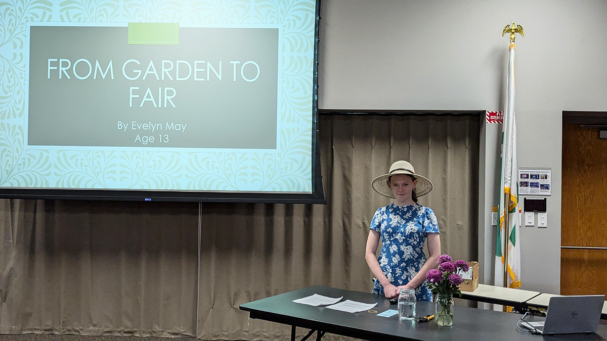 A 4-H youth and her presentation at the 2025 Illustrated Presentation & Video Communication Contest