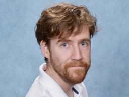 Headshot of Dax Flame