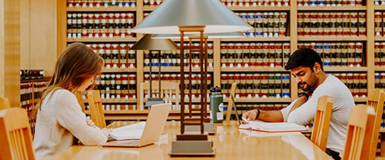 Two law students studying in a law library.
