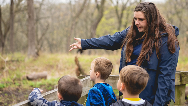 Hannah Miller leads her preschool-aged class, Mudpies, on a hike at the Fontenelle Forest Nature Center in Bellevue in 2022.