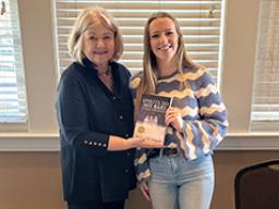 Left: Ellie Maxwell (right) with author Margaret Lukas. Right: The cover design for &ldquo;Spirits Do Not Rest: Heartbreak at Wounded Knee,&rdquo; designed by Maxwell. Courtesy photos.