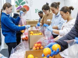 University of Nebraska&ndash;Lincoln students place oranges into bags during SLICE&rsquo;s Engage Lincoln volunteer project at the Food Bank of Lincoln