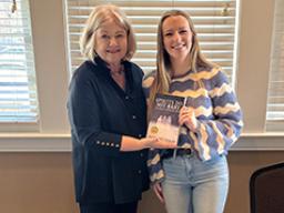 Left: Ellie Maxwell (right) with author Margaret Lukas. Right: The cover design for &ldquo;Spirits Do Not Rest: Heartbreak at Wounded Knee,&rdquo; designed by Maxwell. Courtesy photos.