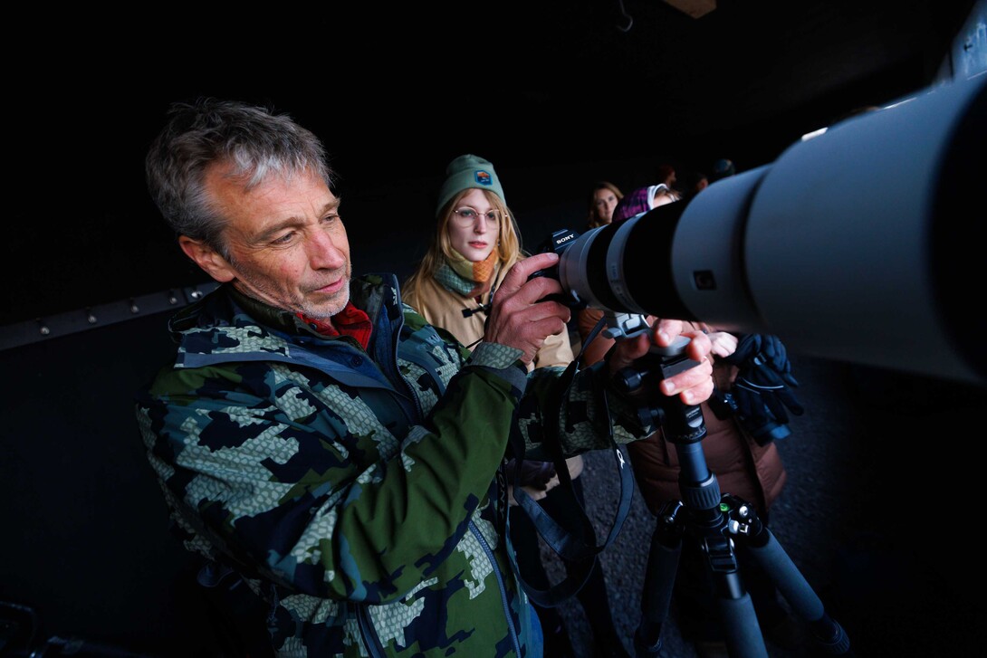 Michael Forsberg (left), research assistant professor in the School of Natural Resources, helps Lilliane Roberts, a senior fisheries and wildlife major, set up their camera as they prepare to watch Sandhill Cranes arrive on the Platte River.