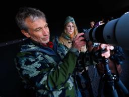 Michael Forsberg (left), research assistant professor in the School of Natural Resources, helps Lilliane Roberts, a senior fisheries and wildlife major, set up their camera as they prepare to watch Sandhill Cranes arrive on the Platte River.