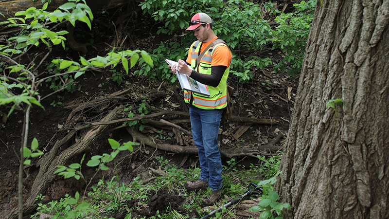 Eric Marrow, environmental senior scientist at JEO Consulting Group, completes a wetland delineation and an assessment  of habitat for northern long-eared bats near Elkhorn NE.