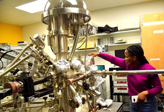 Peace Adegbite works with an ultra high vacuum system equipped with angle-resolved photoemission, scanning tunneling microscopy, X-ray photoemission spectroscopy, low energy electron diffraction and inverse photoemission capabilities.