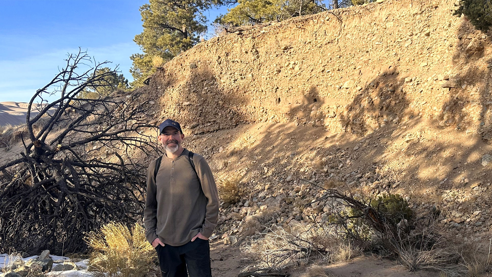 Aaron Lee M. Daigh stands near a soil profile in January 2026 at Great Sand Dunes National Park in Colorado. Courtesy Photo
