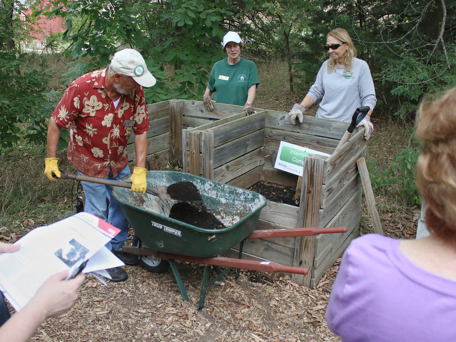 Extension Master Gardener Volunteers presenting a composting demonstration at Pioneers Park Nature Center's backyard composting demonstration area