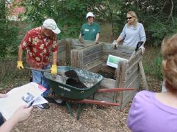 Extension Master Gardener Volunteers presenting a composting demonstration at Pioneers Park Nature Center's backyard composting demonstration area