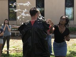 Riah Hatten(on right) throws a pie in the face of Kenneth Pyle as part of a student fundraiser during an Earth Day celebration in the School of Natural Resources. 