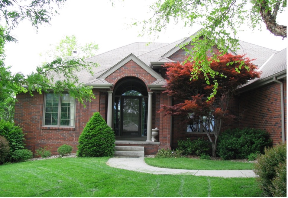 Picture of a house with a lawn. 