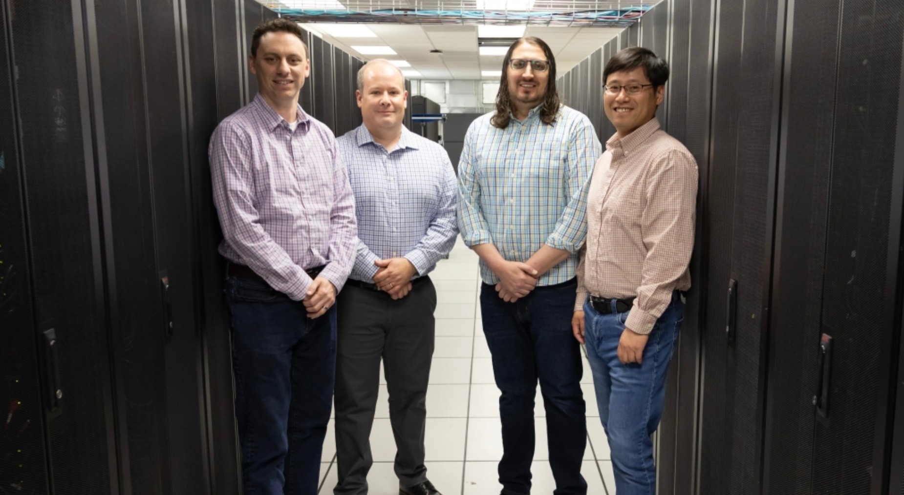 From left: Derek Weitzel, Garhan Attebury, Adam Caprez and Hongfeng Yu in the Holland Computing Center&rsquo;s Lincoln site, located at the Schorr Center. Credit: Cheyenne Rowe / Office of Research and Innovation