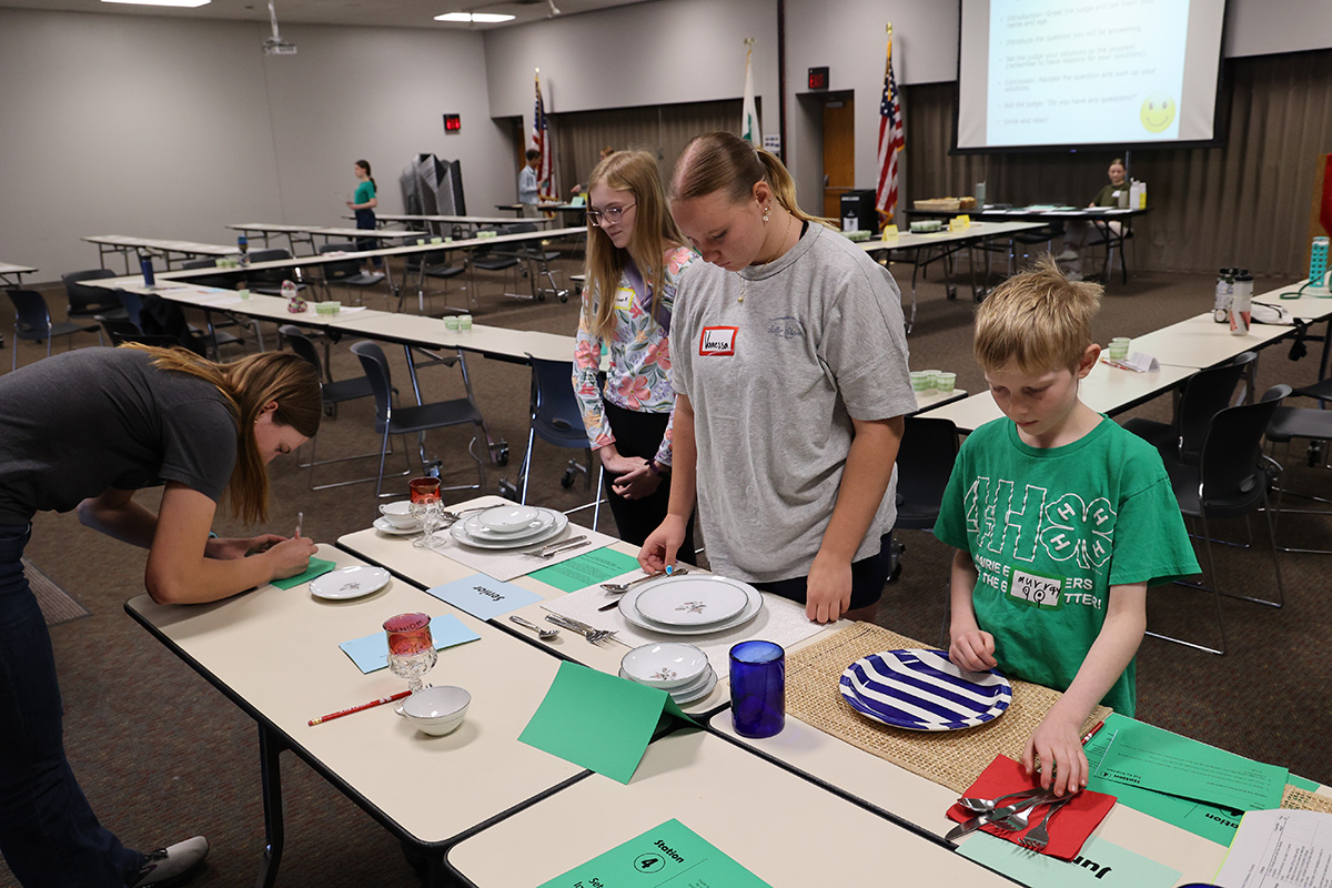 Lancaster County 4-H'ers setting Table Setting place settings at the 2025 4-H Life Challenge Contest