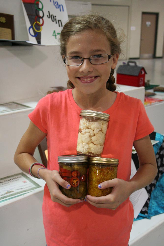 Pictured is top food preservation exhibit, a "three jar pickled exhibit."