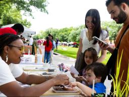  Bellodgia Roberson, a graduate student in agronomy, helps 3-year-old Jasper Molina make a soil profile during an East Campus Discovery Days event in June 2025 (image credit: Liz McCue | University Communication and Marketing).