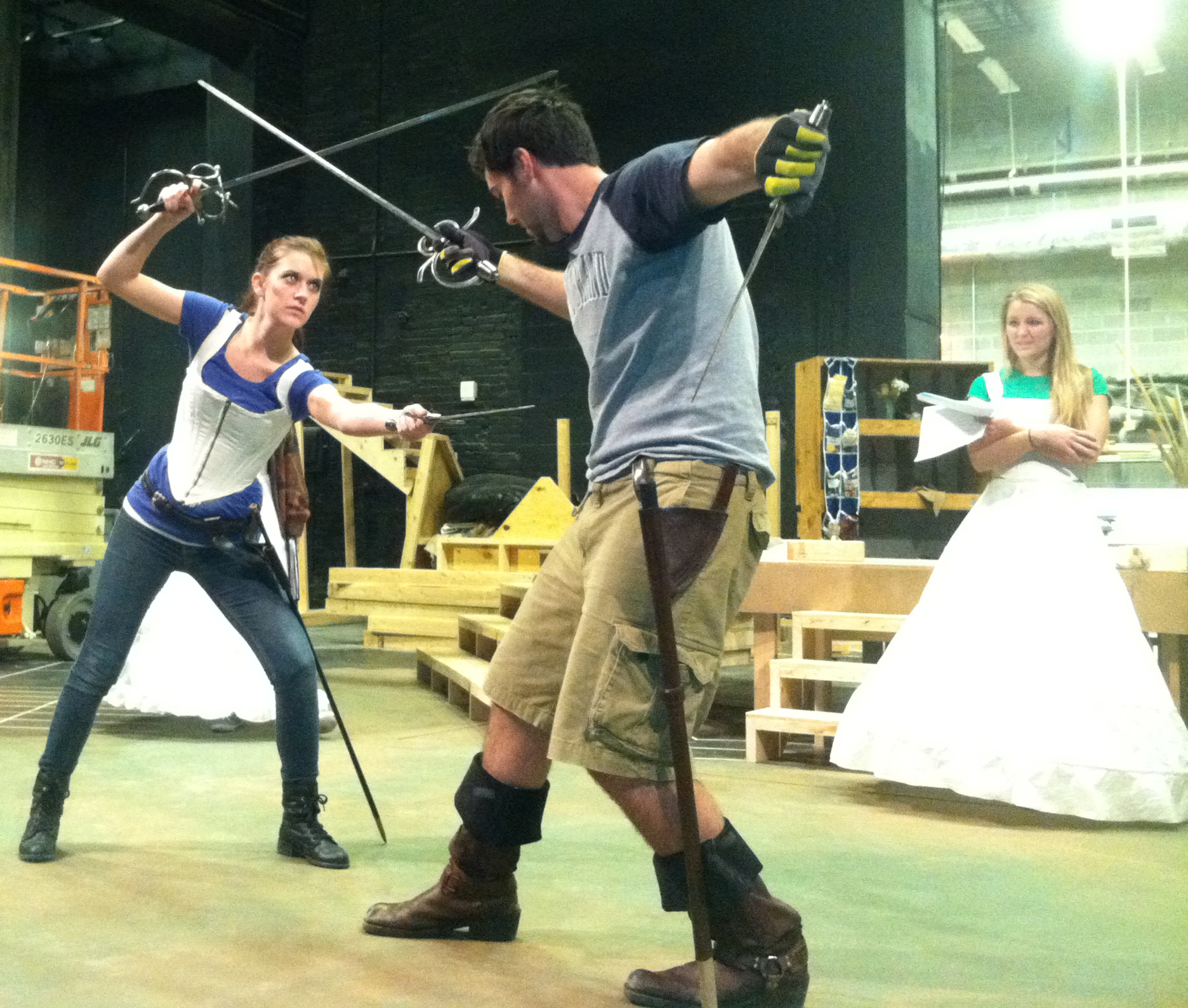 Kayla Klammer (left) and David Michael Fox (center) rehearse a fight scene for "Agravio" as Lucy Myrtue (right) observes.