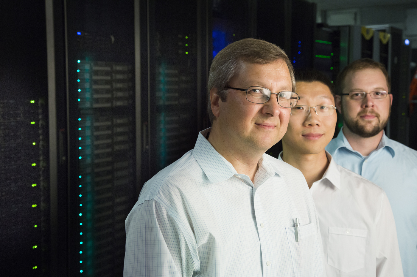 The UNL research team involved in the discovery includes (left) Evgeny Tsymbal, Yong Wang (now at the Pacific Northwest National Laboratory in Richland, Wash.) and J.D. Burton. In the background is a portion of the Holland Computing Center supercomputer.