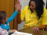 UNL student Rhaniece Choice offers a high five to an elementary school student during an Martin Luther King Jr. outreach event earlier this year.