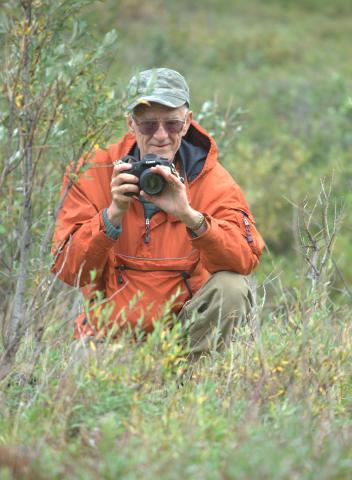 Paul Johnsgard photographs a family of Willow Ptarmigan at Denali National Park, Alaska in 2010. (Photo by Scott Johnsgard)