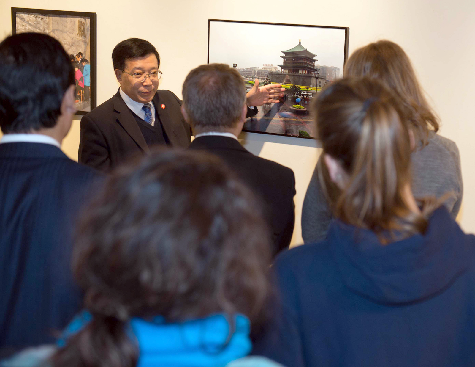 Song Xiaoping, vice president at Xi'an Jiaotong University, leads a Nov. 14 tour of a photography exhibition in Richards Hall.