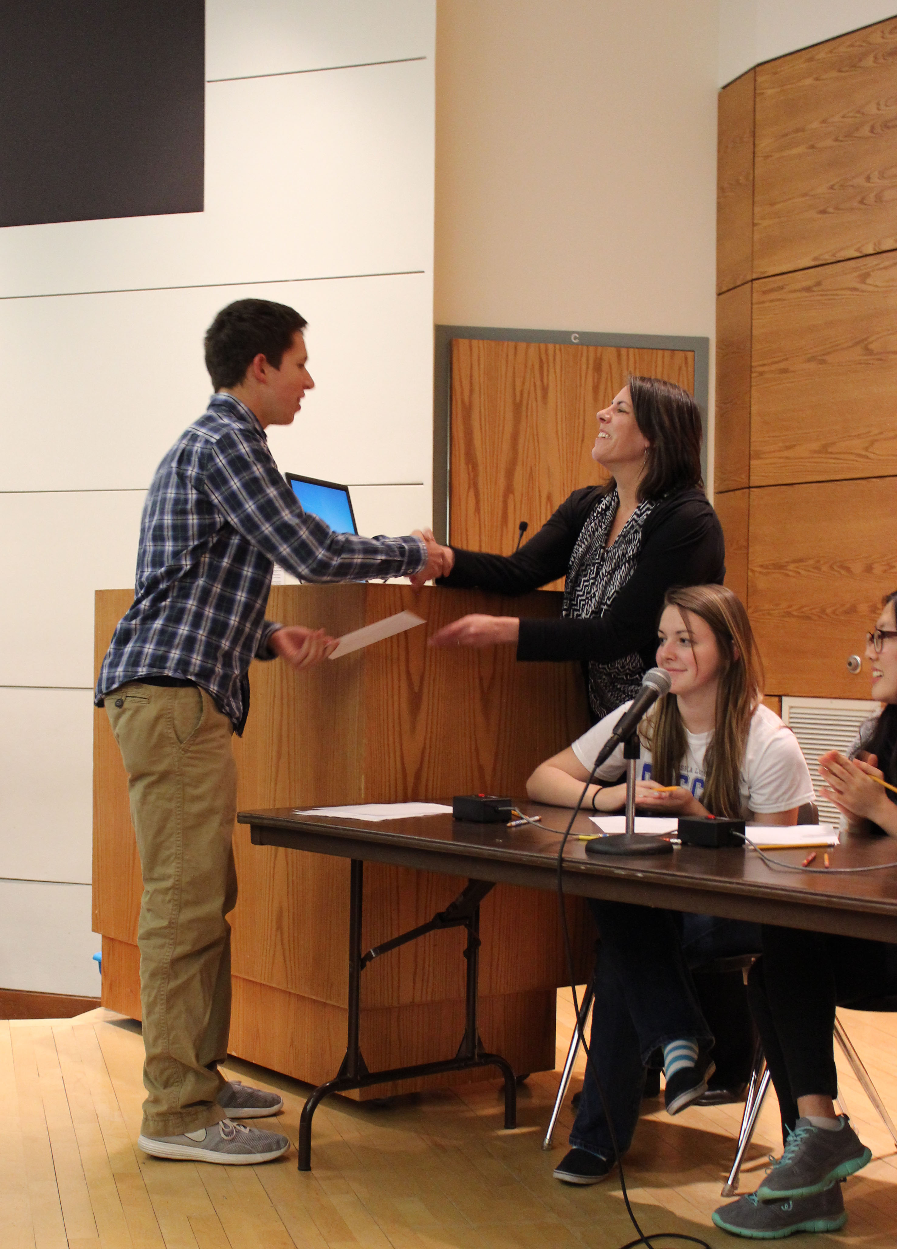 Ryan Goding from Omaha Central accepts his scholarship letter from Dr. Judy Walker