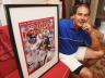 Sports Illustrated photographer Damian Strohmeyer holds one of his most famous photos from Super Bowl 42, of the key plays in the game. (Photo courtesy of The Lexington Minuteman/Ann Ringwood.)