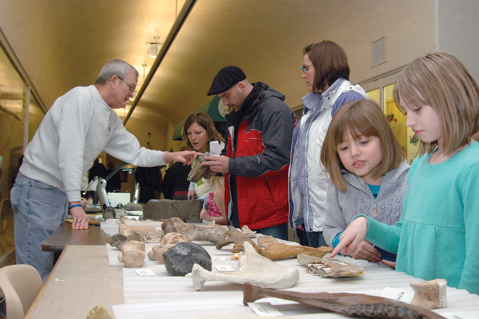 George Corner (at left), collections manager for the NU State Museum, talks with visitors during the 2011 Dinosaurs and Disasters.