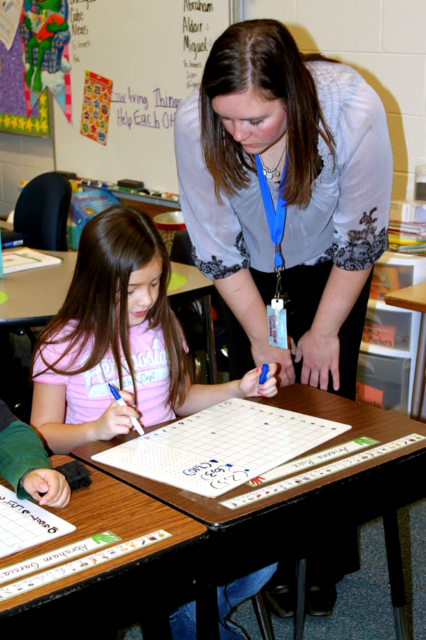 Dana Henry works with one of her second-grade students at Knickrehm in Grand Island.